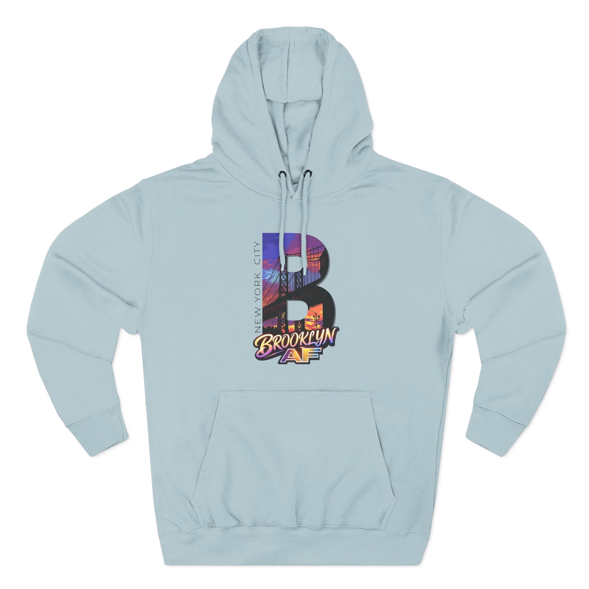 Pale blue hoodie, flat lay front view, bold oversized B with a Brooklyn Bridge sunset skyline graphic and Brooklyn AF logo.