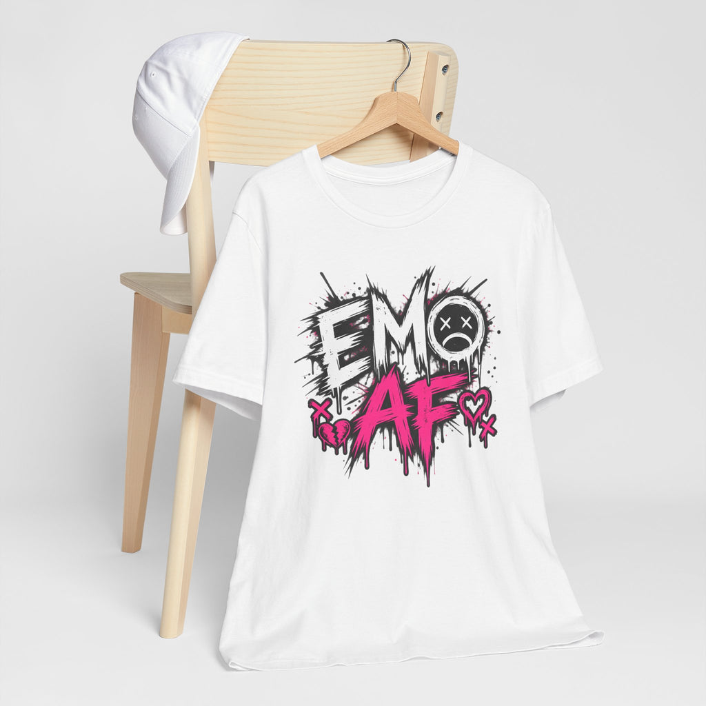White EMO AF tee on a wooden hanger beside a chair, front print showing