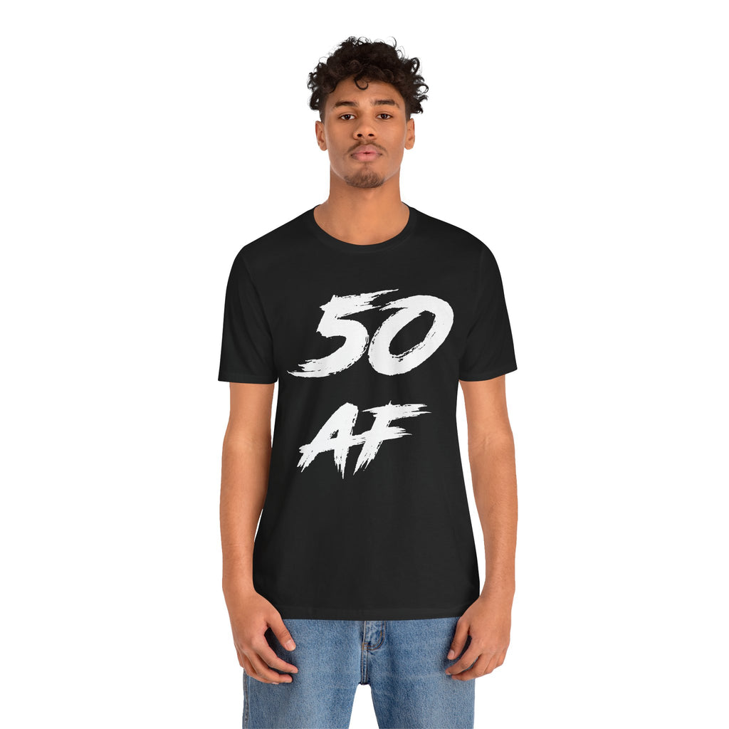 Man in the black 50 AF birthday t-shirt and jeans, front view on a plain backdrop