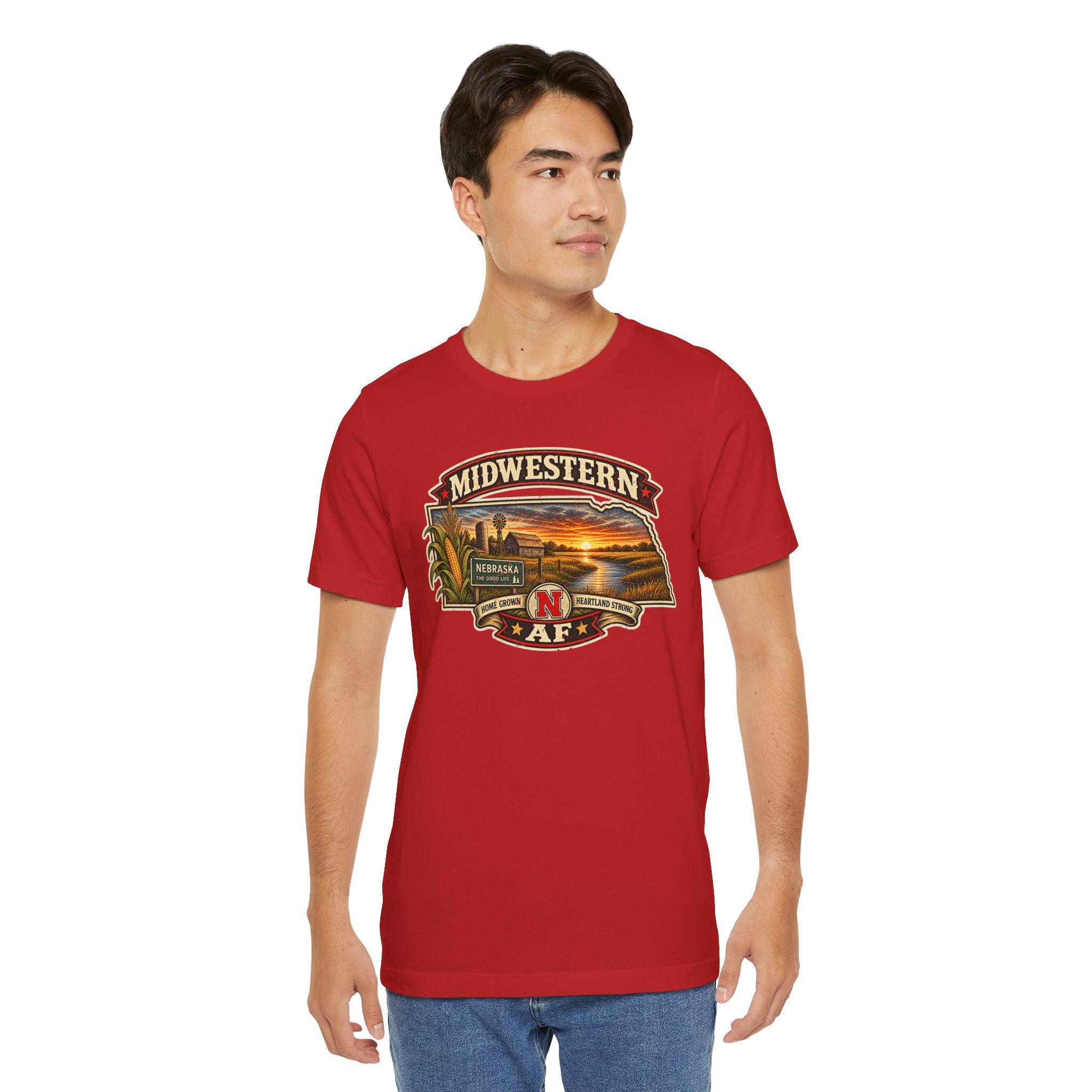 Man wearing the red Nebraska tee, vintage Nebraska farm graphic printed on the front
