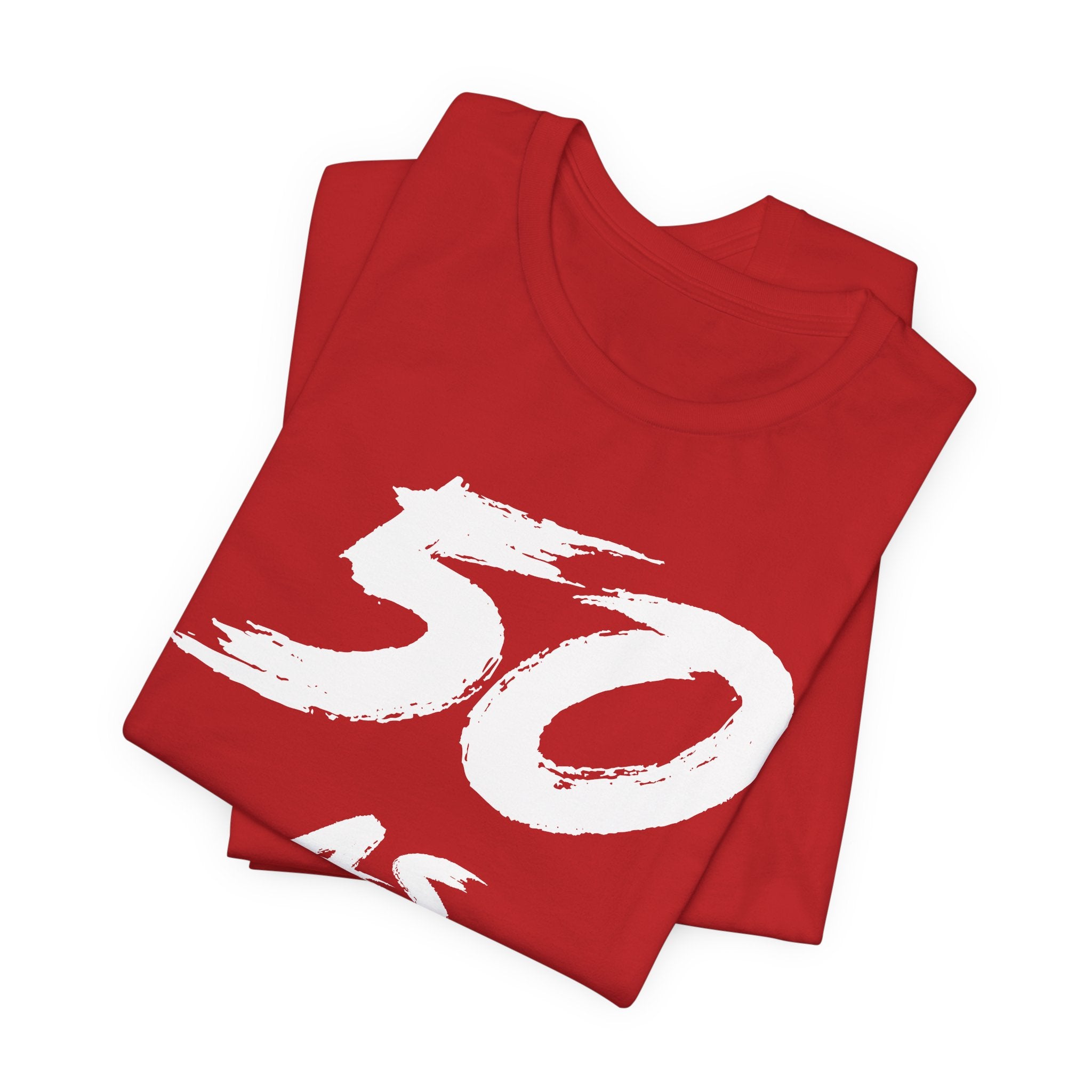 Folded red birthday tees stacked with the white 50 across the top fold