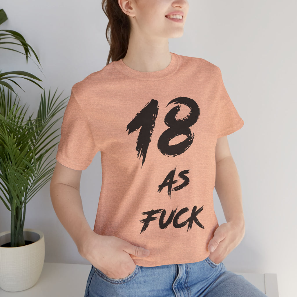 Woman by a houseplant in the Heather Peach tee, black 18 AS FUCK print
