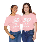 Two women arm in arm in matching pink 50 AS F**K birthday tees