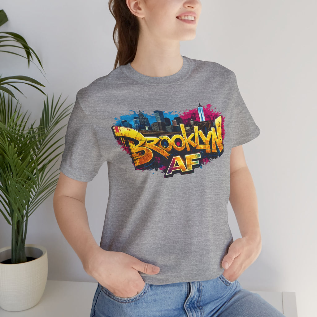 Athletic Heather t-shirt worn by a model, close-up of chest print showing graffiti Brooklyn AF lettering and skyline.