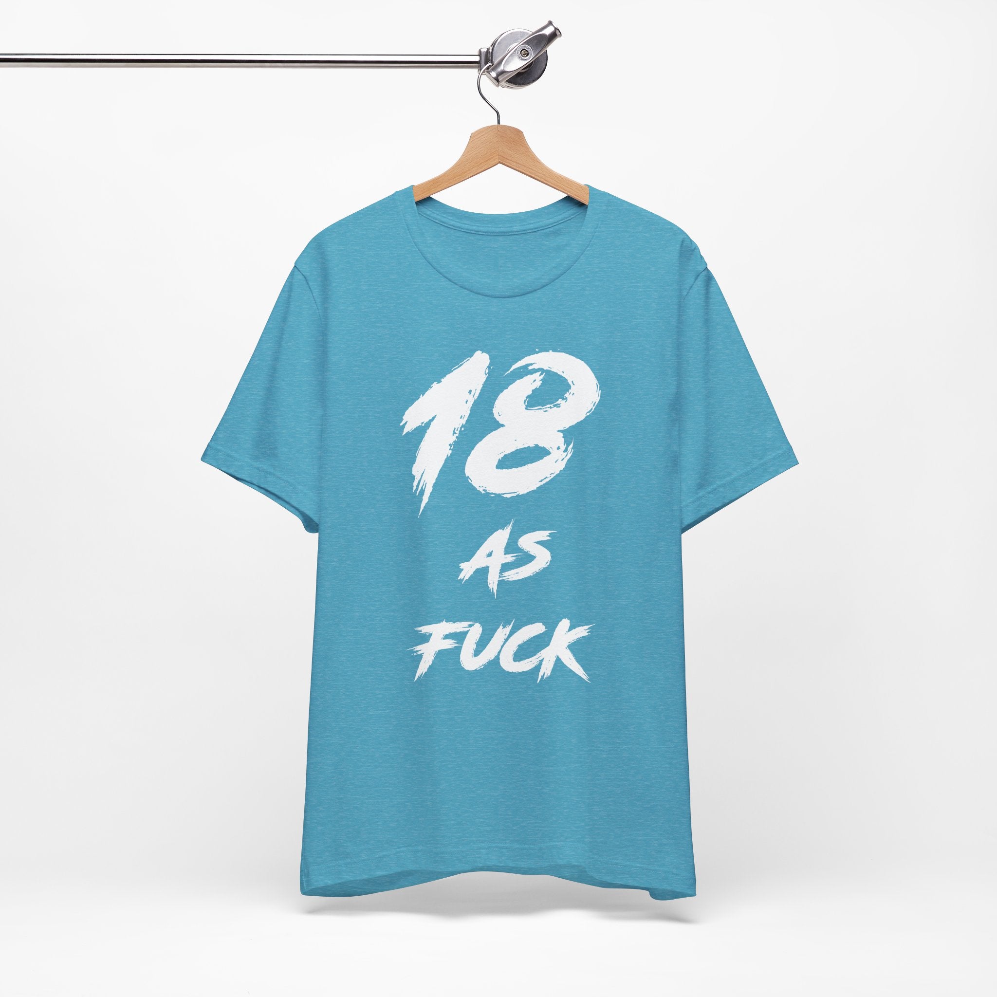 Heather Aqua birthday tee hanging on a hanger, white 18 AS FUCK graphic facing front