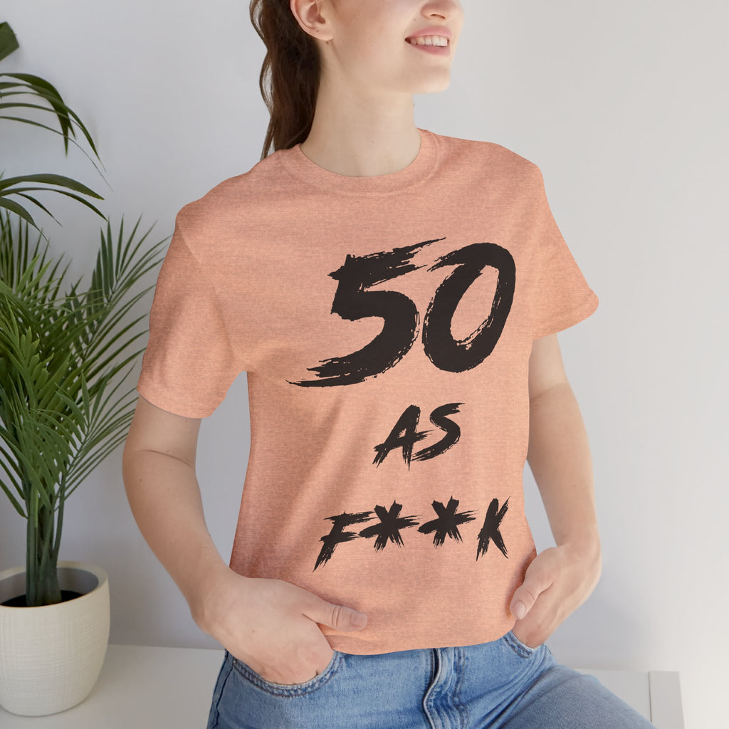 Woman by a houseplant in the Heather Peach tee, black 50 AS F**K print