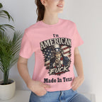 Pink tee worn by female model, close-up, Uncle Sam graphic with "I'm American As Fuck, Made In Texas" text