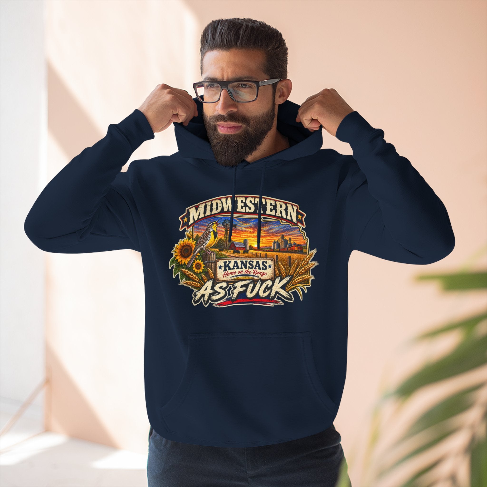Bearded man wearing the navy Kansas As Fuck hoodie, hands on the hood