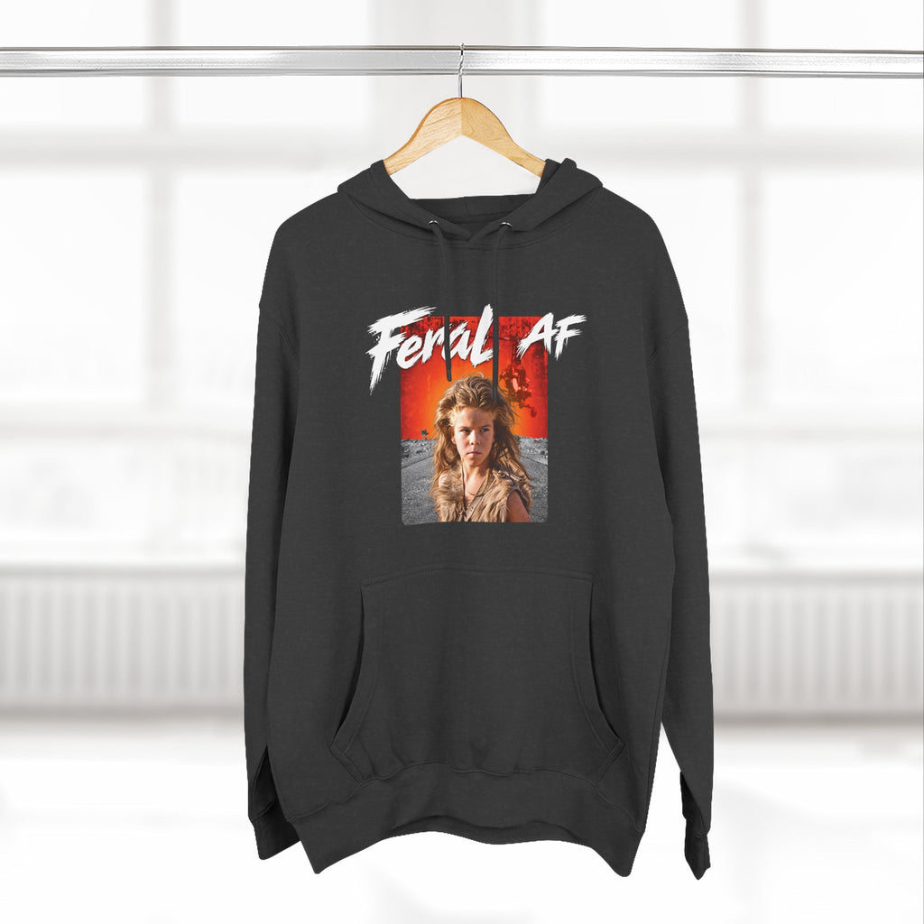 Charcoal Heather Feral AF hoodie hanging on a wooden hanger in front of a window