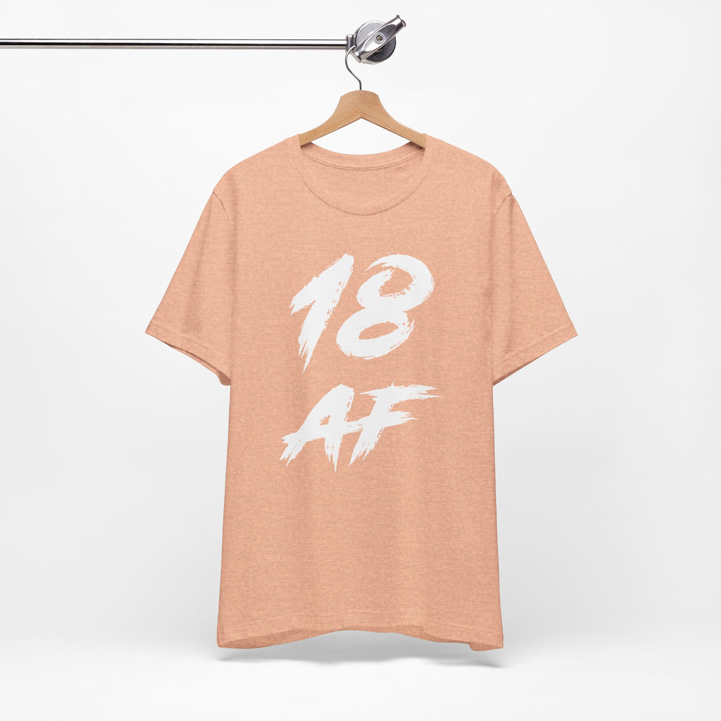 Heather Peach birthday tee on a wooden hanger showing the white front print