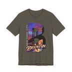 Army green t-shirt, flat lay front view, with a bold B and a purple-orange Brooklyn Bridge sunset skyline graphic.