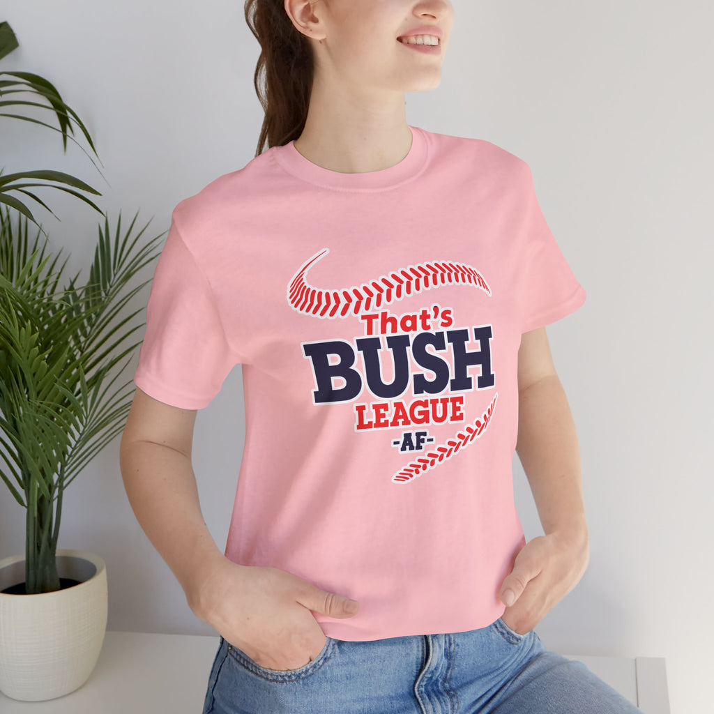 Woman wearing the Pink Bush League AF tee beside a houseplant, front graphic centred