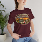 Woman in the maroon Nebraska tee indoors, showing the corn and sunset state graphic