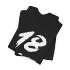 Folded black birthday tees stacked, the white 18 filling the top fold