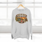 Heather grey Nebraska hoodie hanging by a window with the sunset farm badge