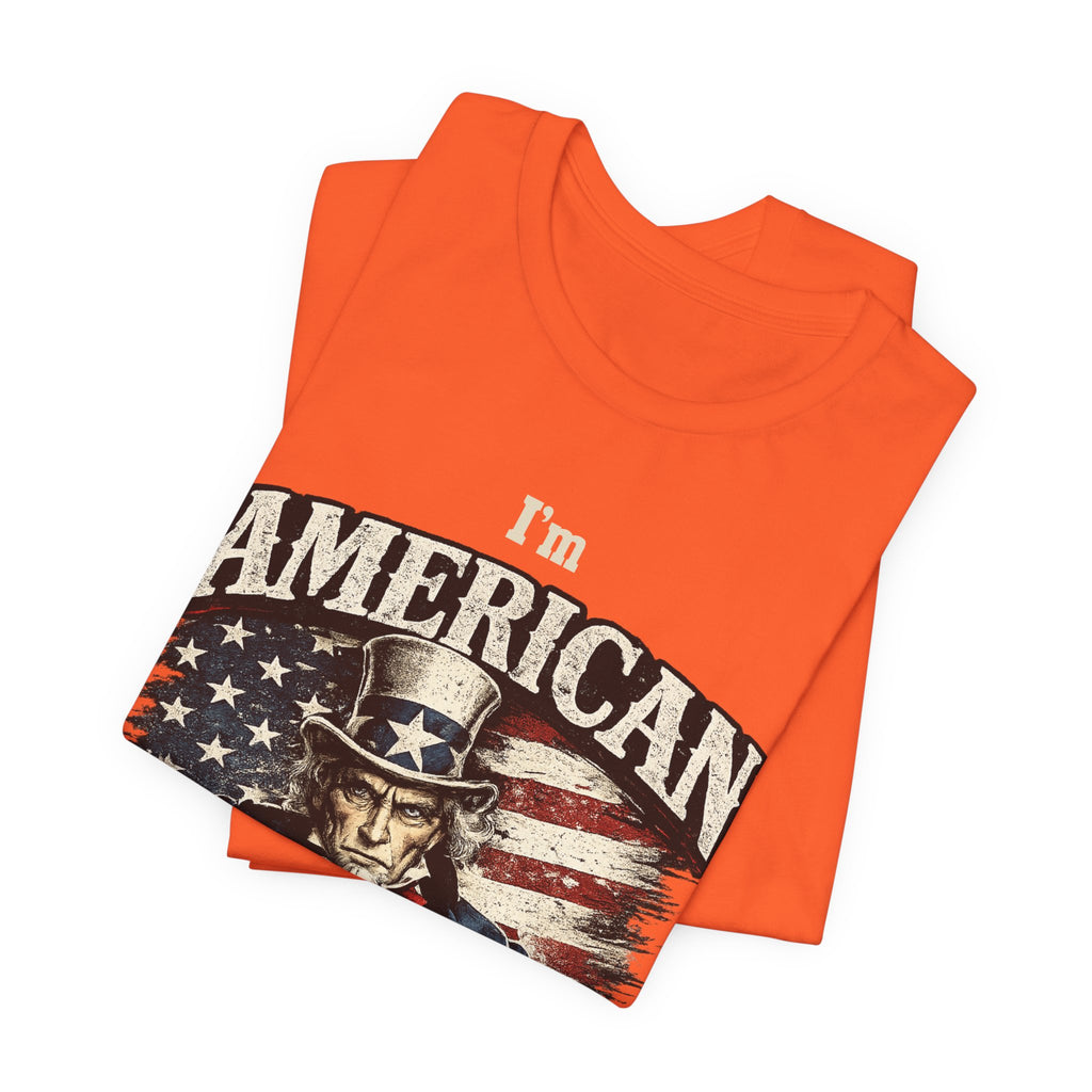 Orange t-shirt folded into a stack, top fold showing the Uncle Sam graphic and I'm American lettering.