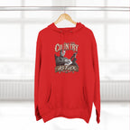 Red Country As Fuck hoodie hanging on a wooden hanger by a window