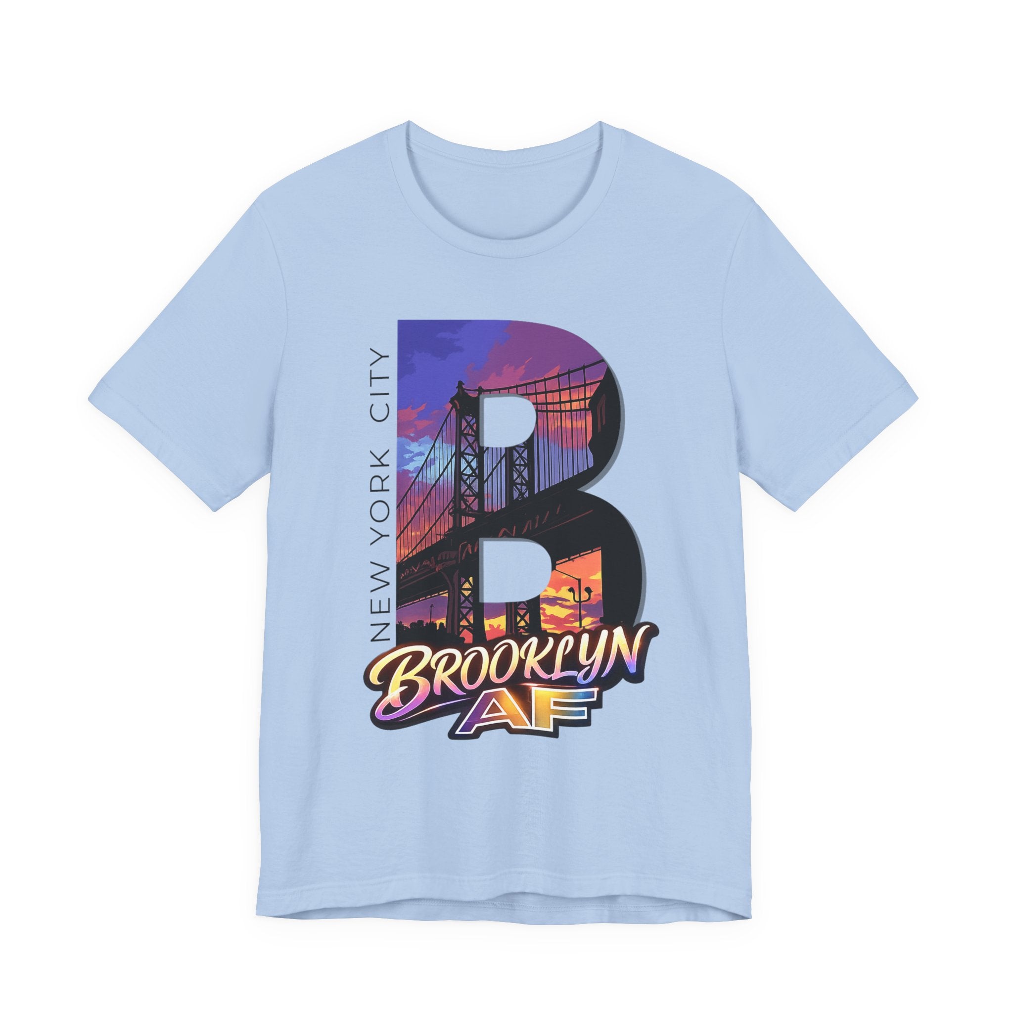 Light blue t-shirt, flat lay, with a bold oversized "B" featuring a Brooklyn Bridge sunset skyline graphic.
