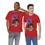 Two models wearing red t-shirts, front view, both featuring the 'B' Brooklyn Bridge sunset skyline graphic