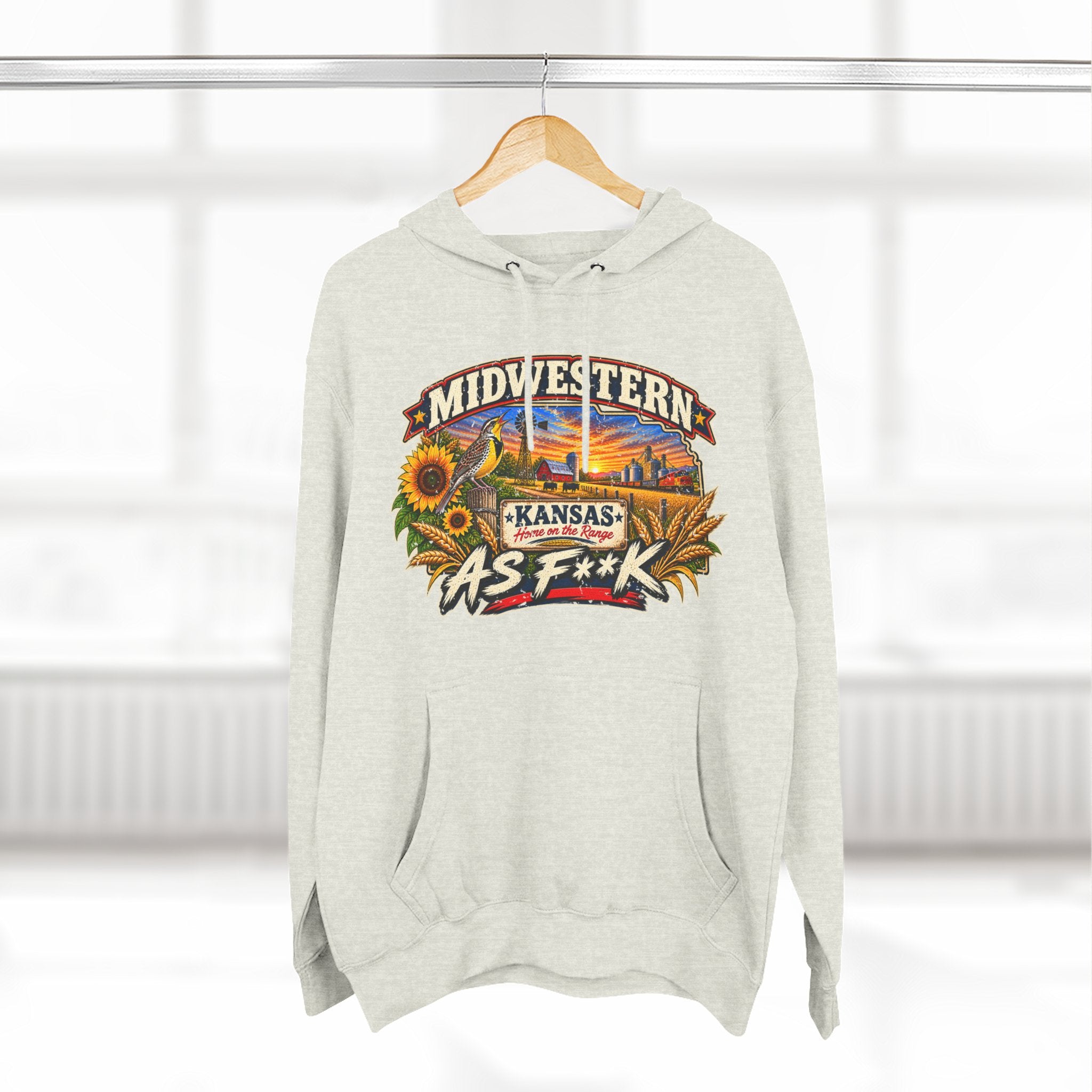 Oatmeal heather Kansas As F**K hoodie hanging by a window, front print on show