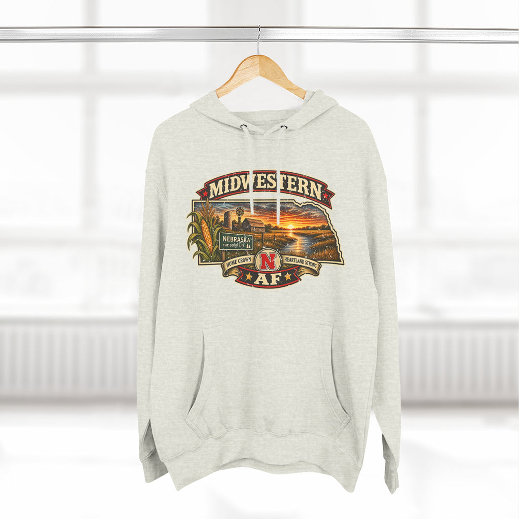 Oatmeal heather Nebraska hoodie on a wooden hanger, front graphic centred