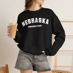 Woman holding an iced coffee in the Black personalized Nebraska sweatshirt, white varsity print