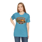 Woman wearing the heather aqua Nebraska tee, Midwestern AF badge across the front