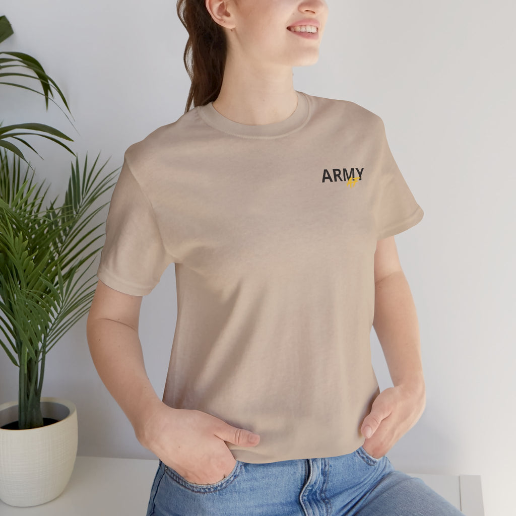 Woman wearing the Army veteran T-shirt in Tan beside a potted plant