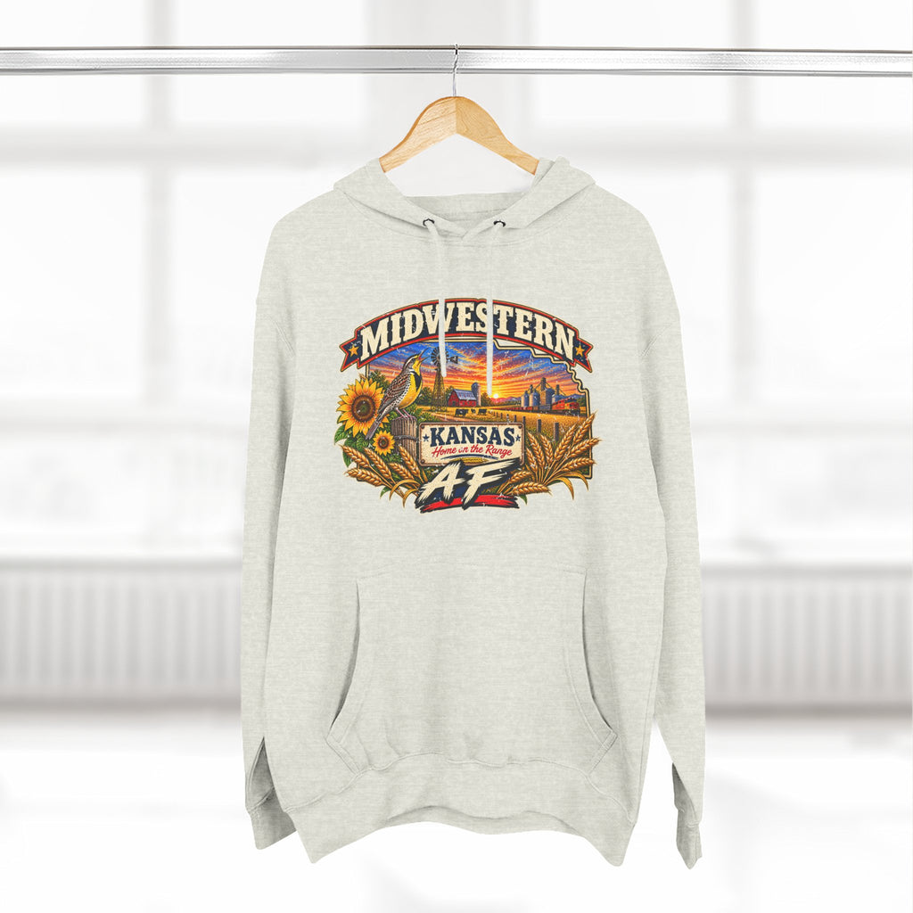 Oatmeal heather Kansas AF hoodie hanging by a window, front print on show