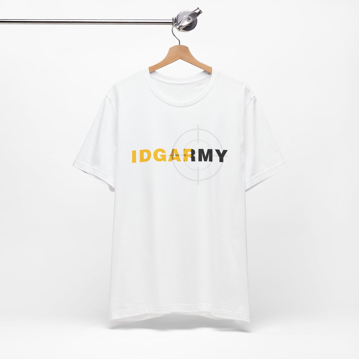 White IDGAF Army T-shirt on a wooden hanger against a pale wall, front print centred