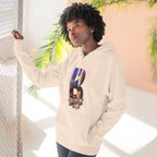 Oatmeal heather hoodie worn by a model against a window, oversized B with a Brooklyn Bridge sunset skyline graphic.