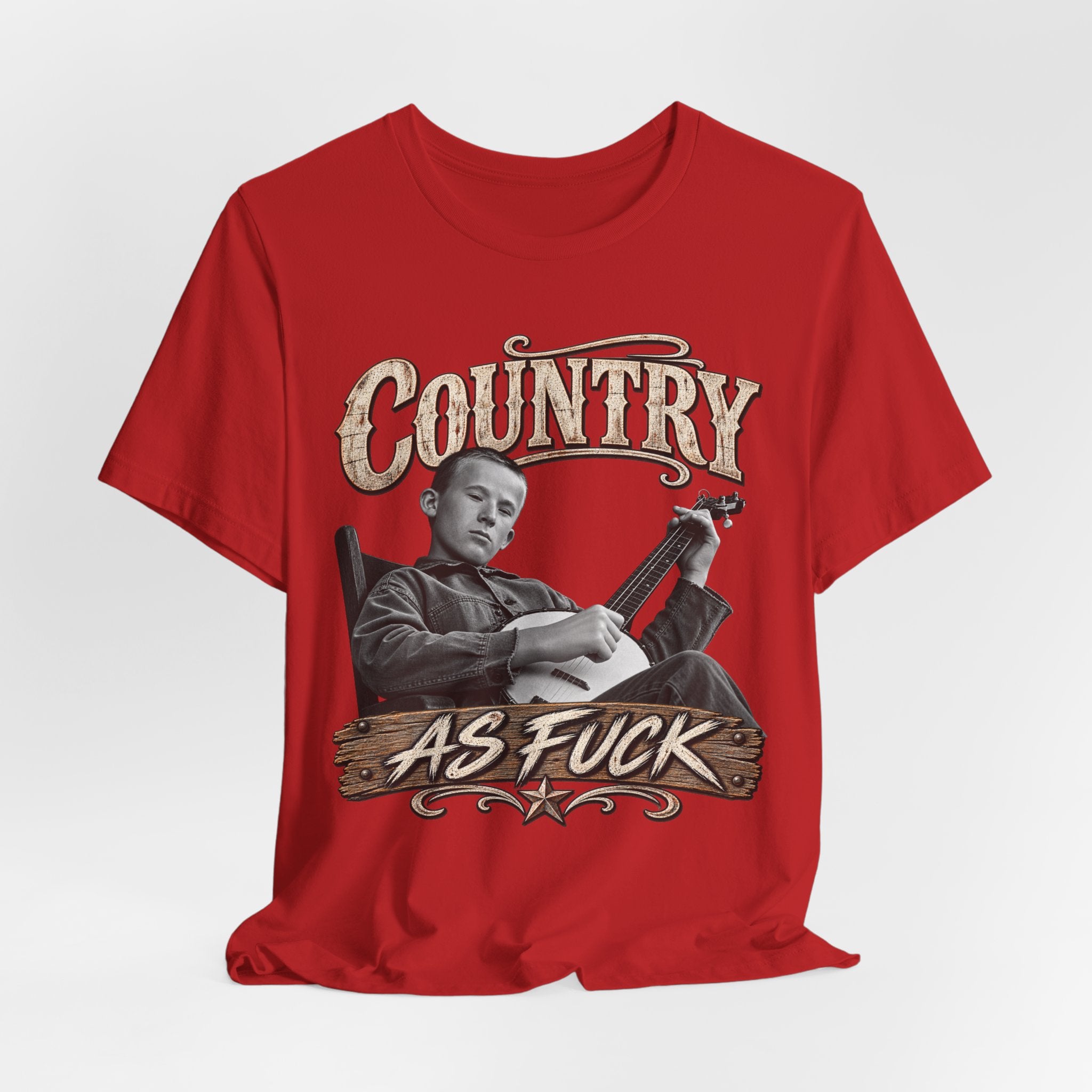 Red Country As Fuck tee laid flat, distressed banjo-player front graphic