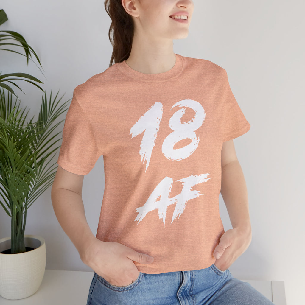 Woman by a houseplant in the Heather Peach tee, white 18 AF print