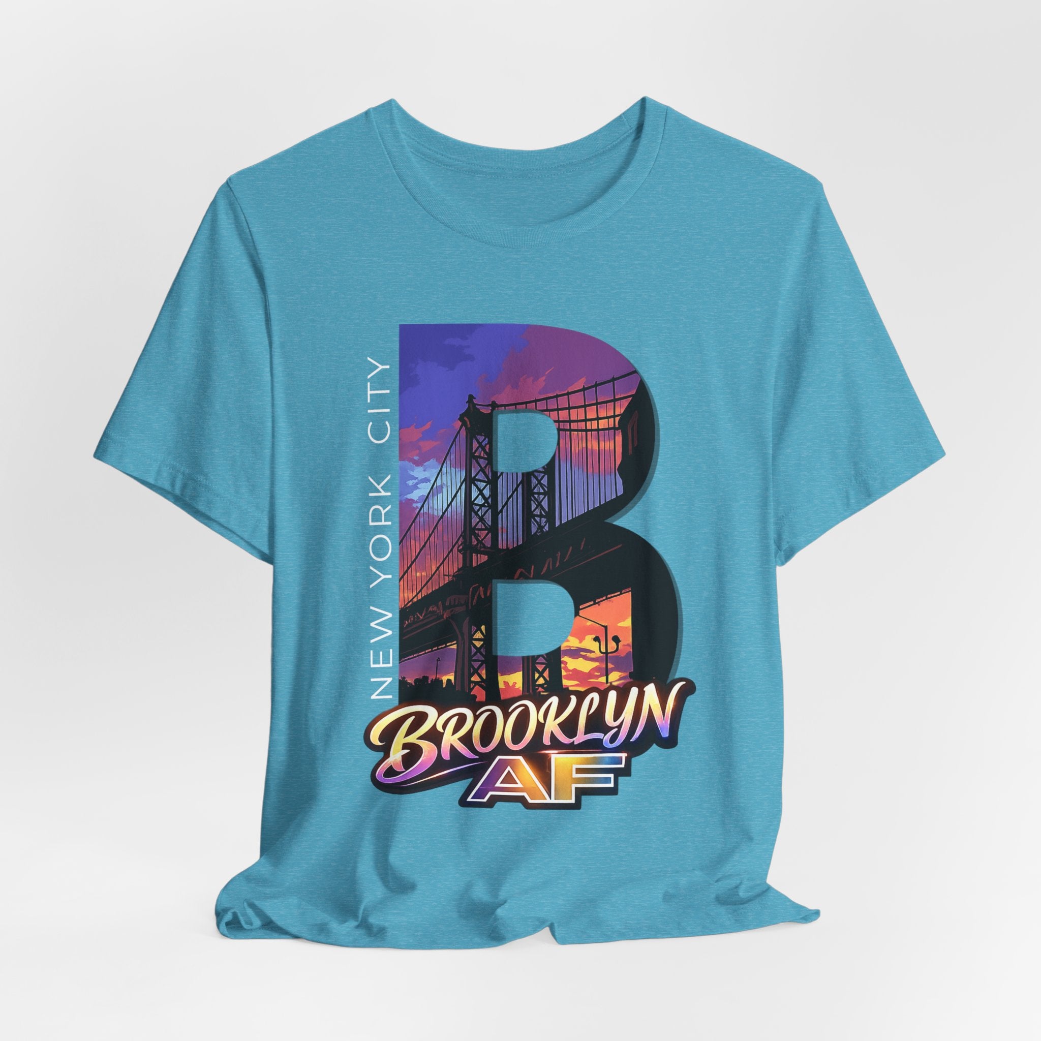 Teal t-shirt flat lay, front view with full 'B' graphic, Brooklyn Bridge sunset skyline and 'Brooklyn AF' logo