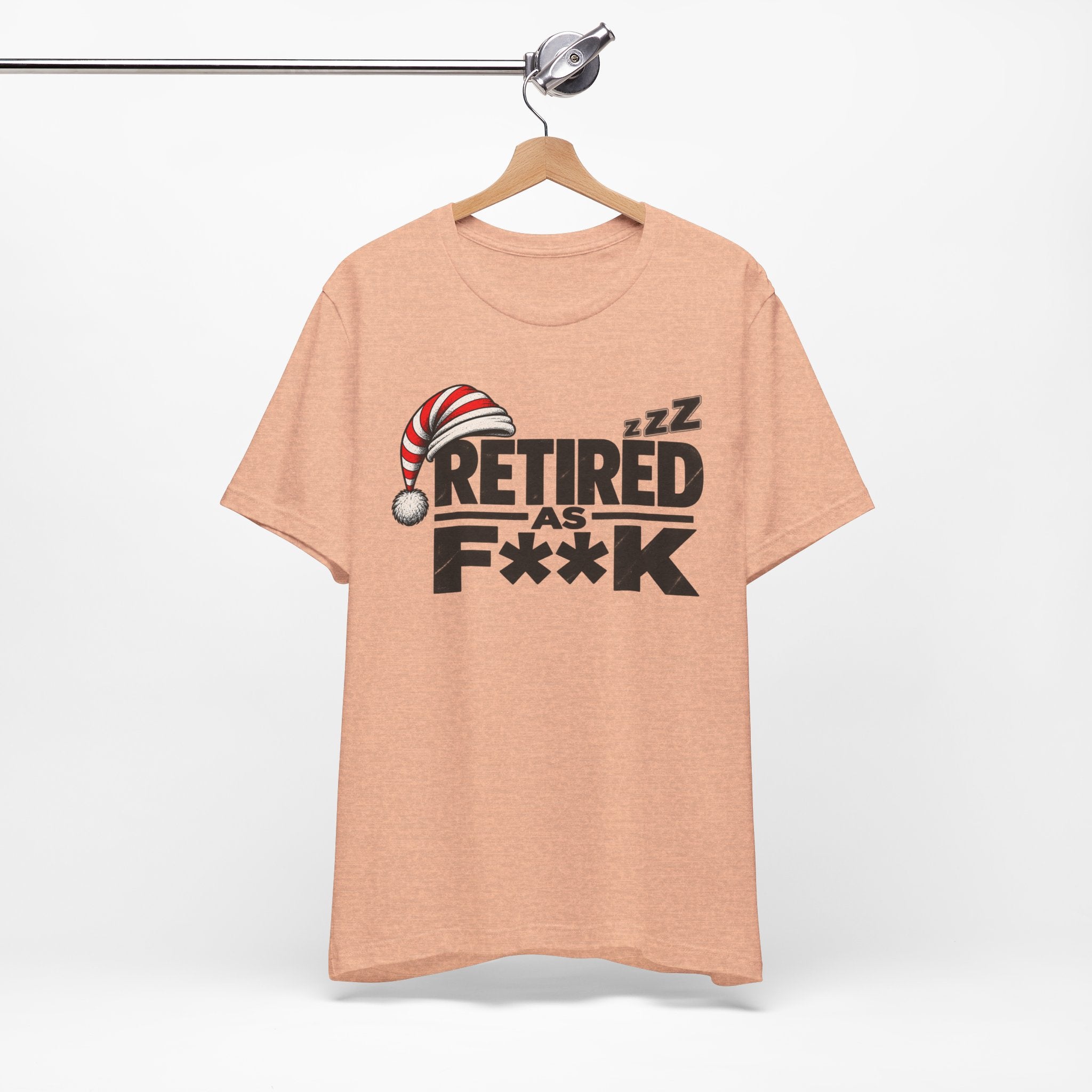 Heather Peach Retired As F**K tee on a wooden hanger against a plain wall