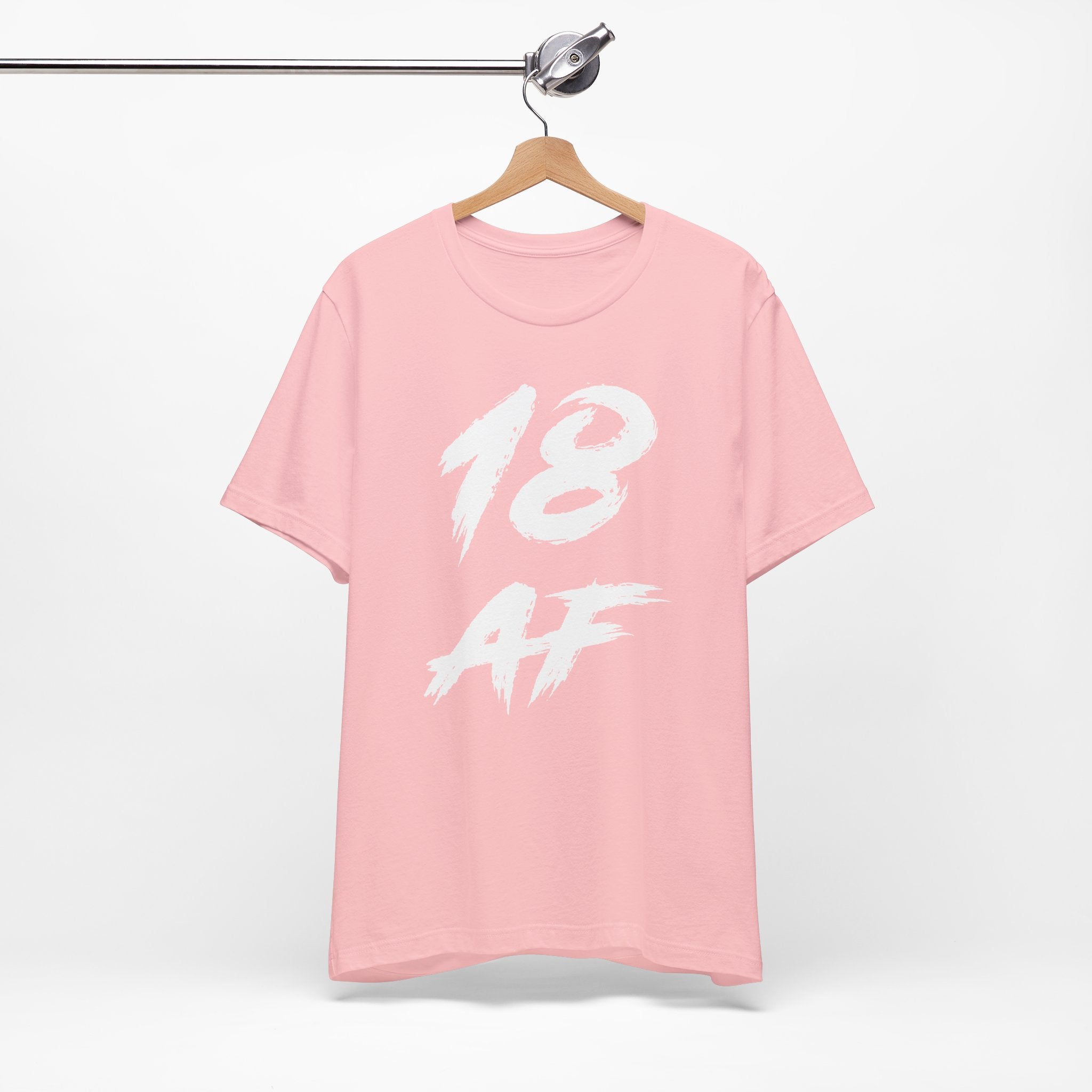 Pink birthday t-shirt on a hanger with the white 18 AF brush print