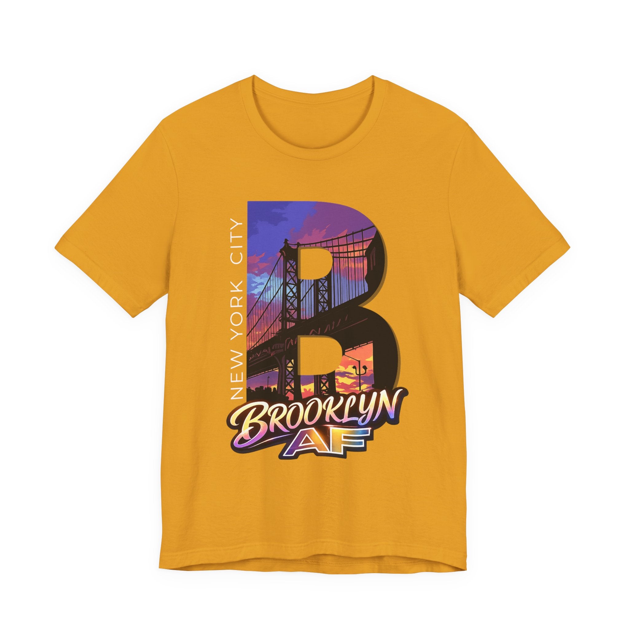Mustard yellow t-shirt, flat lay front view, with a bold B and a purple-orange Brooklyn Bridge sunset skyline graphic.