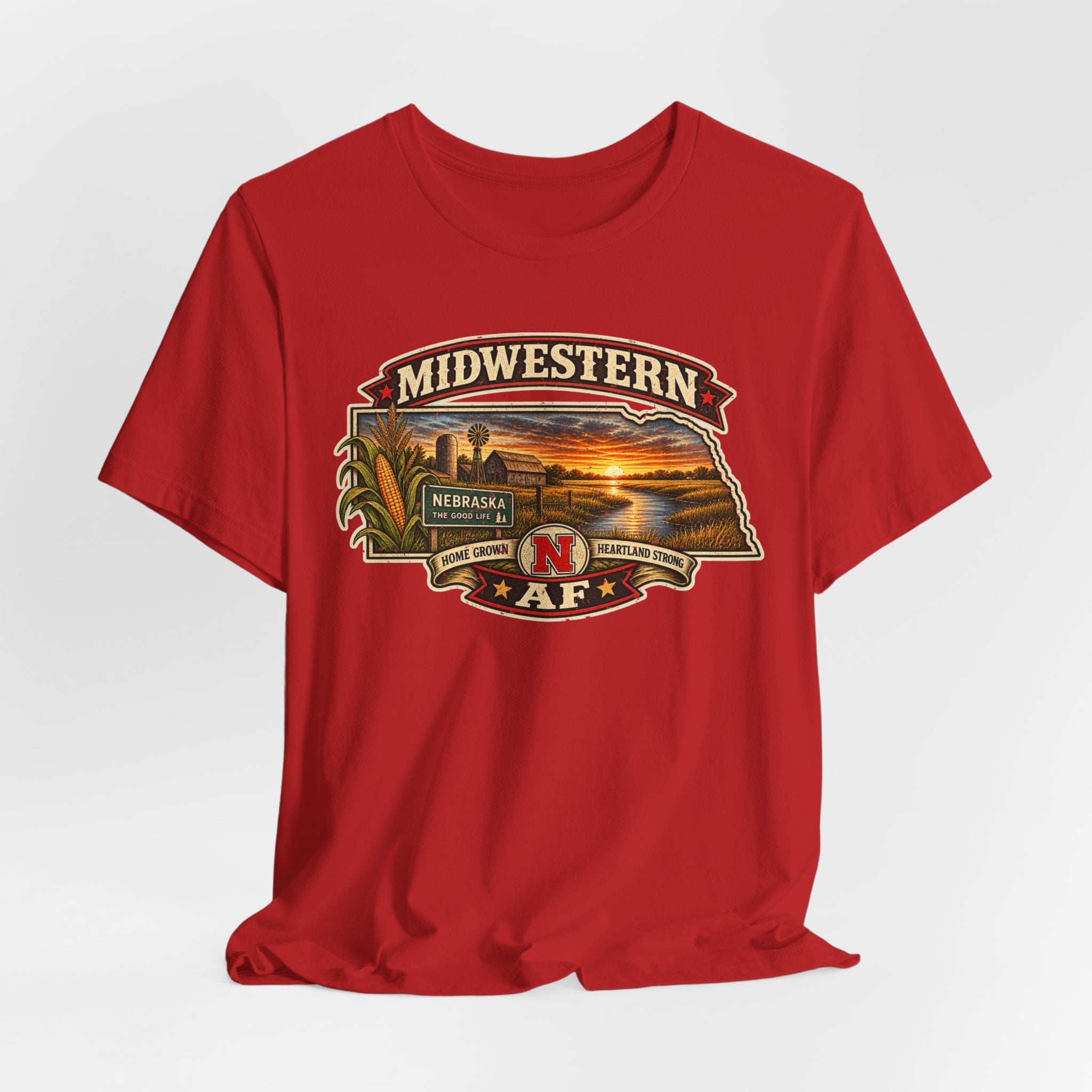 Red Nebraska T-shirt draped flat showing the Midwestern AF badge and The Good Life sign