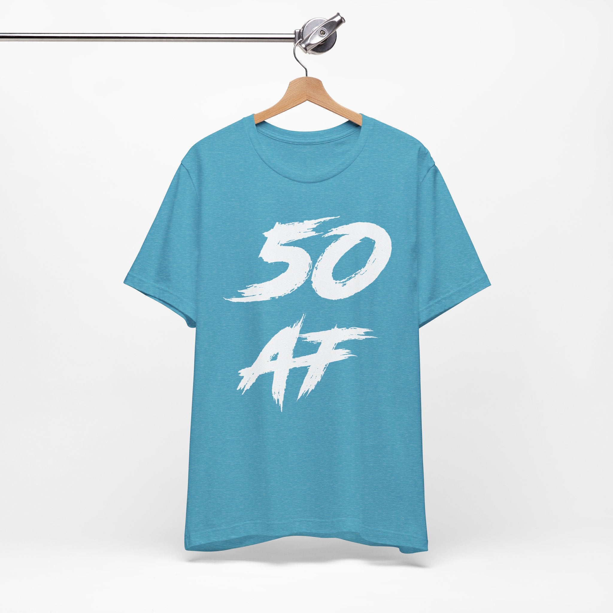 Heather Aqua birthday tee hanging on a hanger, white 50 AF graphic facing front