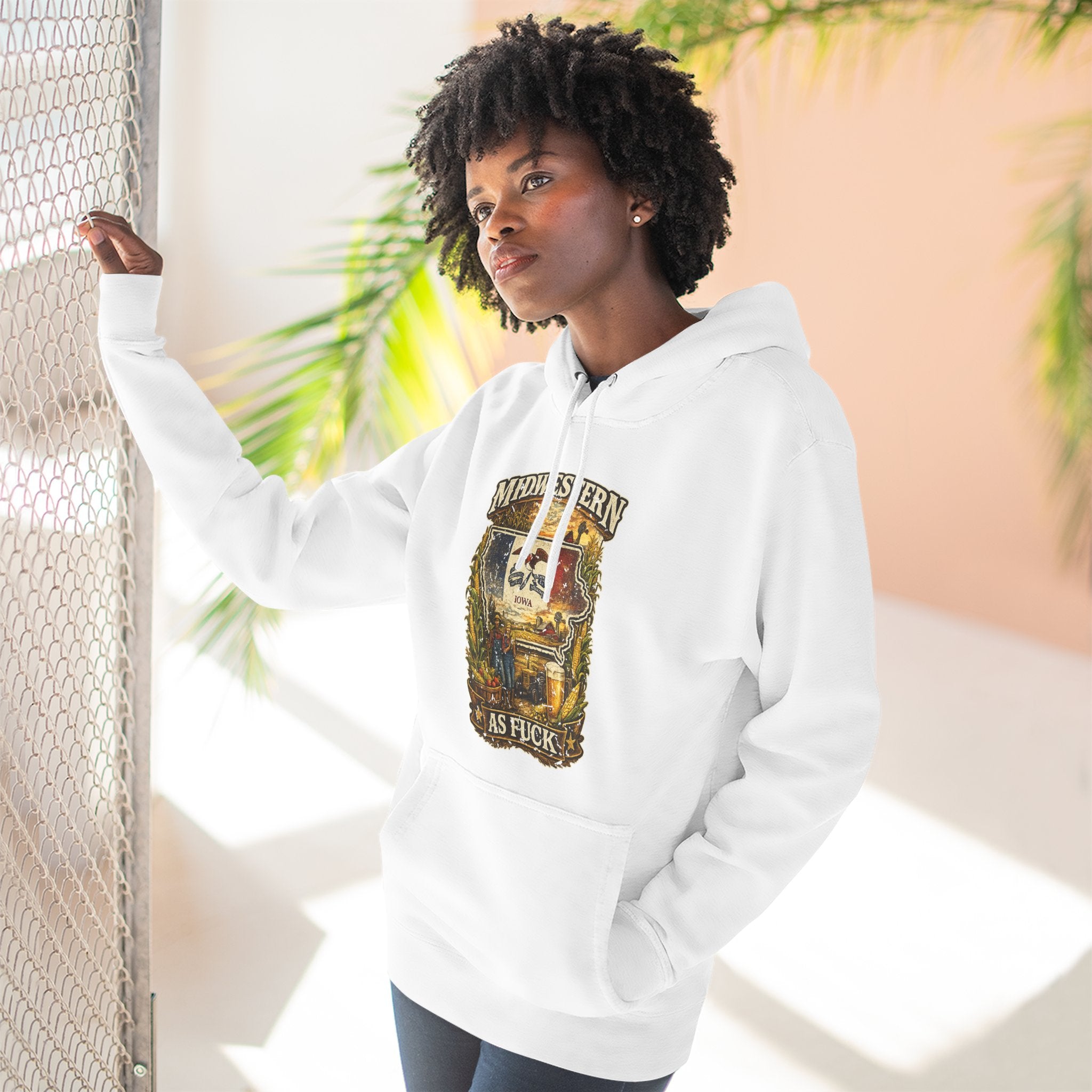 Midwestern As Fuck Iowa Hoodie – product photo 2 featuring a distressed vintage design featuring the outline of Iowa overlaid with the Iowa state flag, surrounded by towering corn stalks, rolling farmland, a classic red barn, a windmill, a tractor, and an overflowing harvest basket