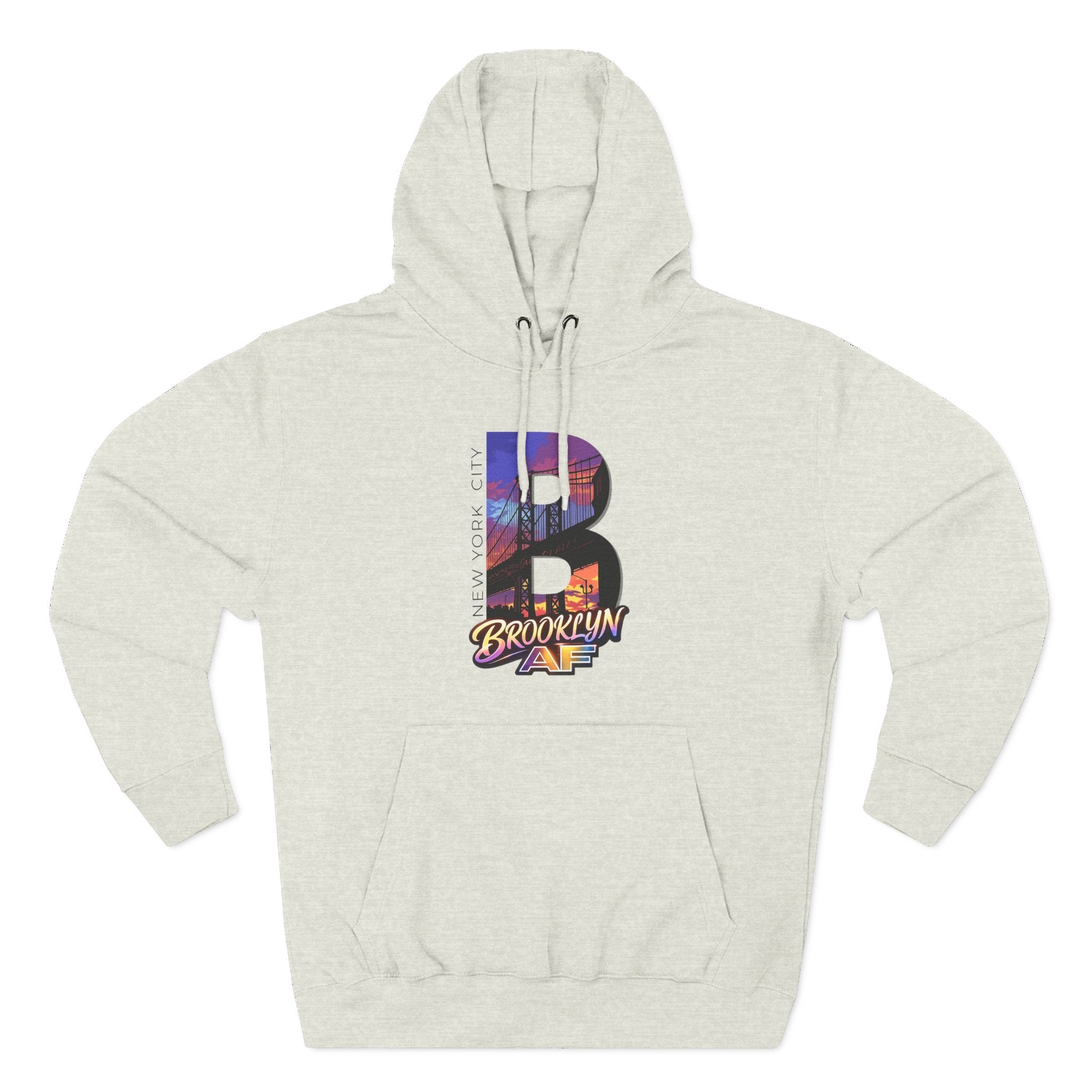Light heather off-white hoodie, flat lay front view, oversized B with a Brooklyn Bridge sunset skyline graphic.