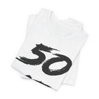 Folded white birthday tees stacked, the black 50 showing on the top fold