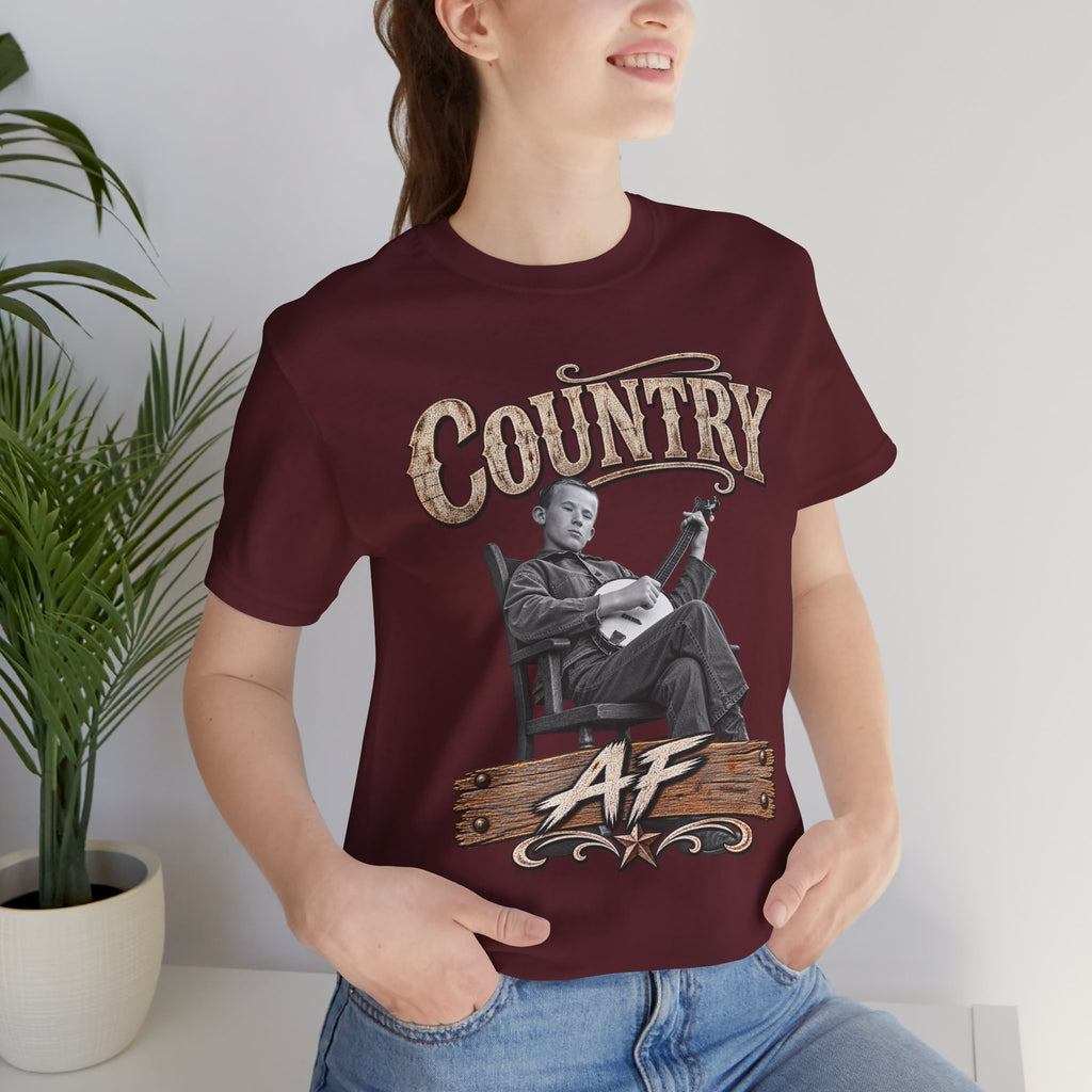 Woman by a potted plant in the Maroon Country AF tee