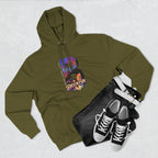 Army green hoodie flat lay styled with jeans, white belt, and sneakers, showing the oversized "B" skyline graphic.