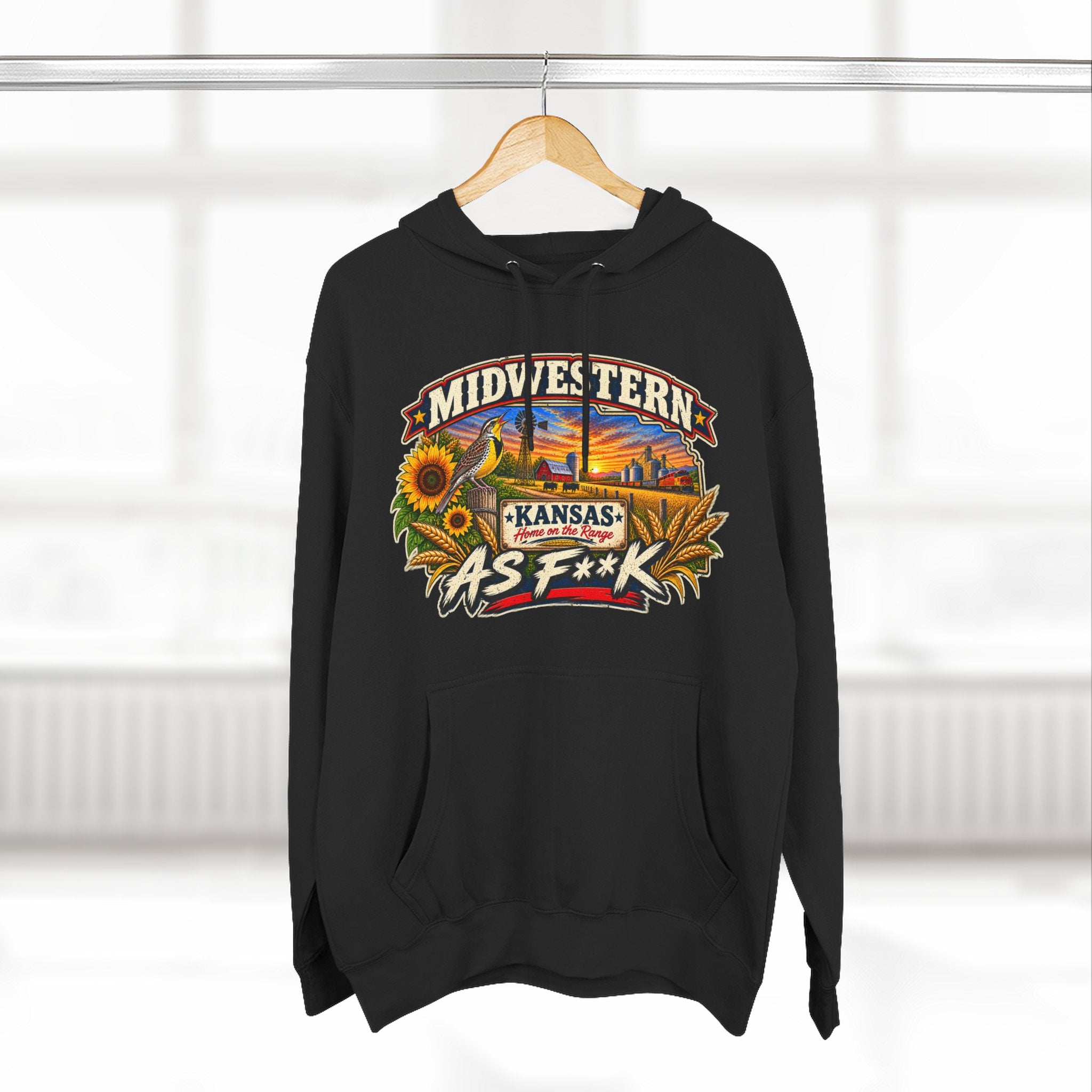 Black Kansas As F**K hoodie on a wooden hanger by a bright window