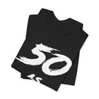 Folded black birthday tees stacked, the white 50 print filling the top fold