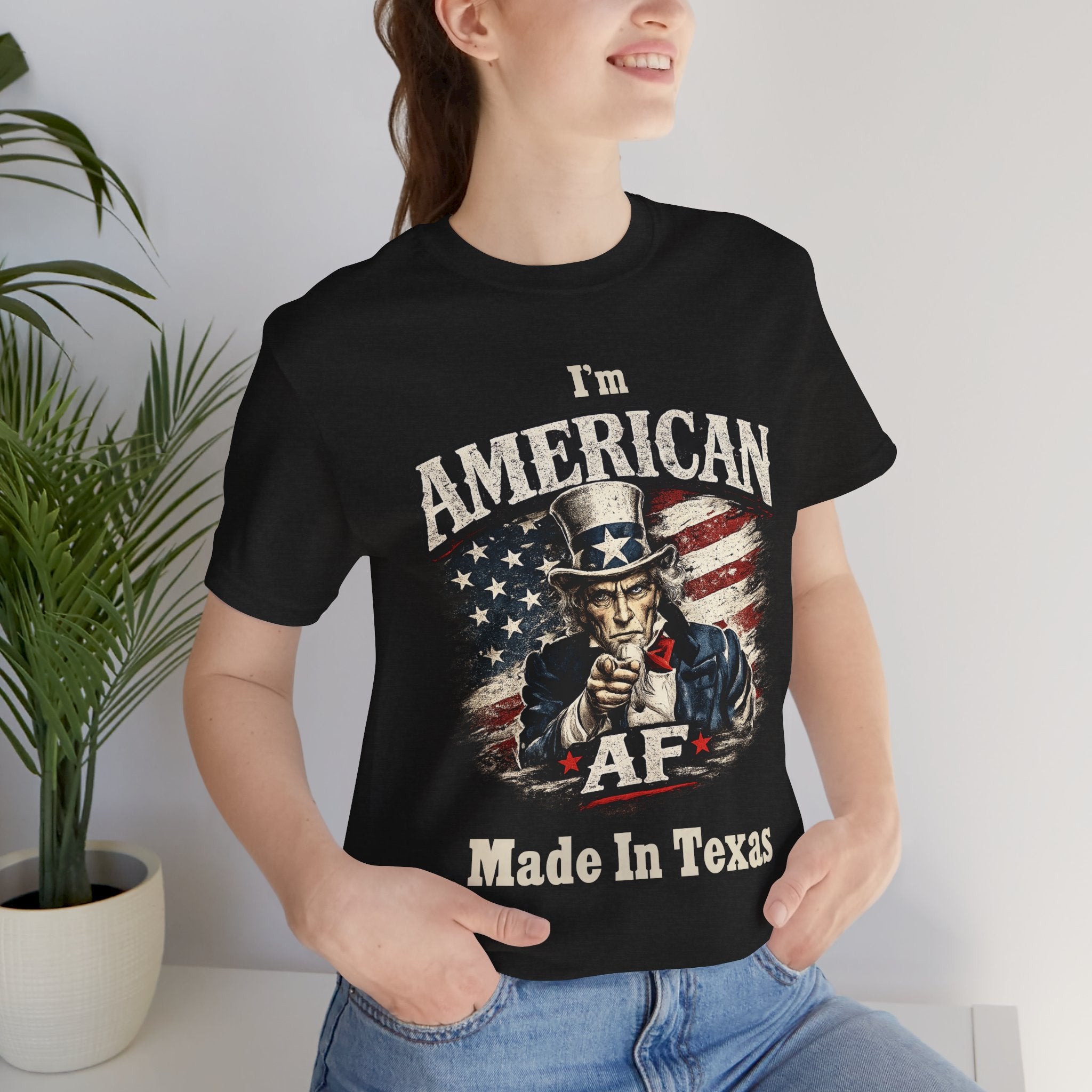 Black t-shirt worn by a female model, close-up torso crop of the full Uncle Sam AF Made In Texas print.
