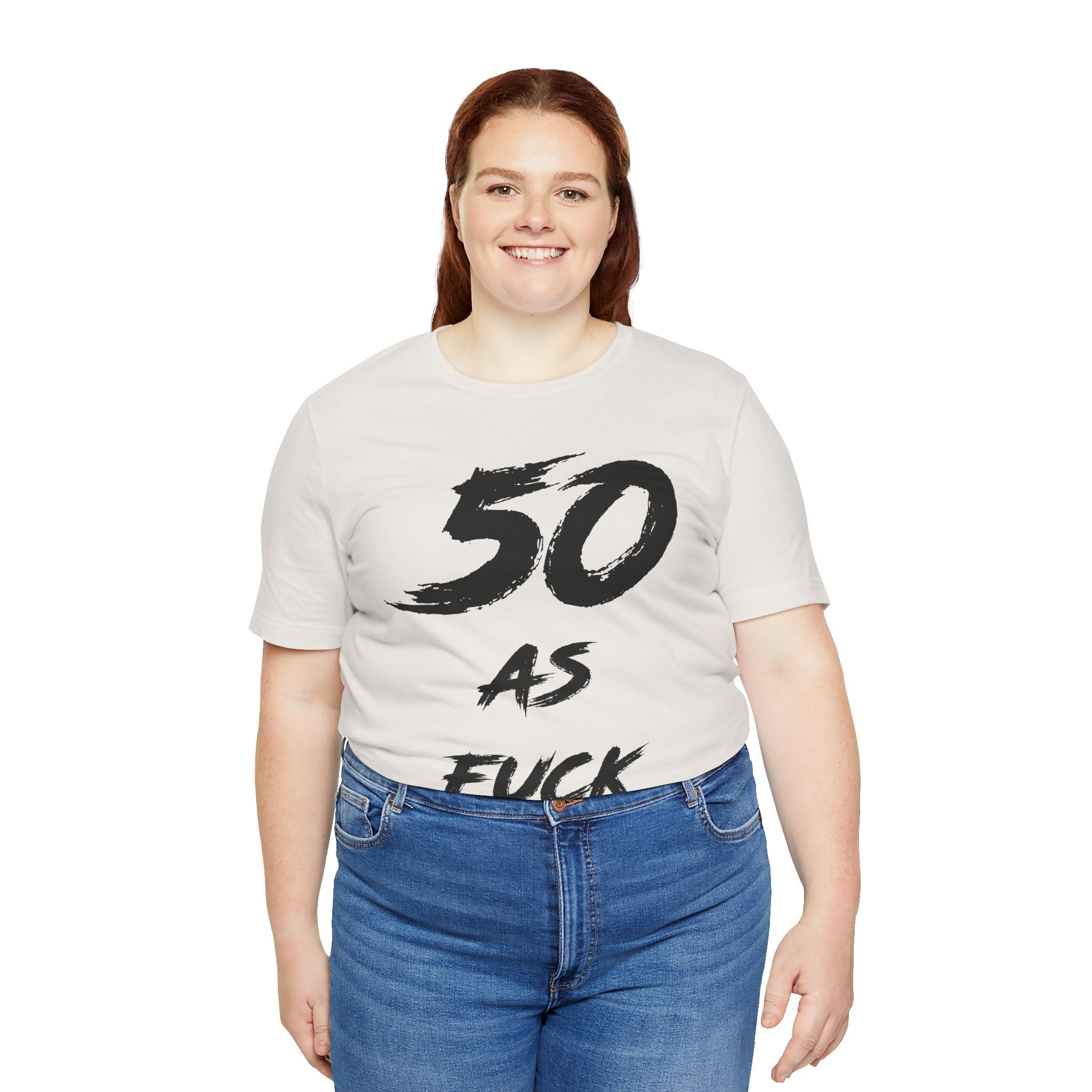 Smiling woman wearing the Vintage White 50 AS FUCK birthday tee with jeans