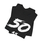Folded black birthday tees stacked, the white 50 print filling the top fold
