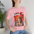 Woman wearing the Pink Feral AF T-shirt indoors, the red-orange wasteland print on her chest